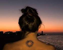 She has a sun tattoo behind her neck.